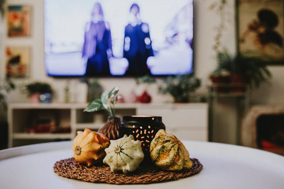 embark Warm and inviting indoor scene featuring decorative gourds and ambient lighting on a table.
