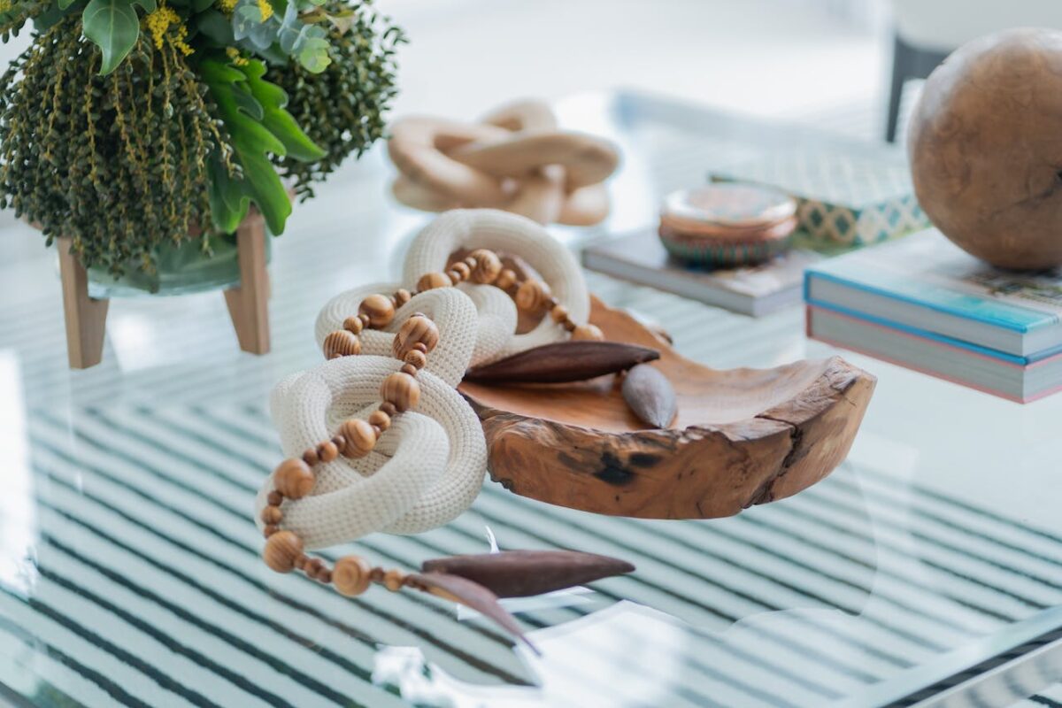 services-04 Stylish handmade decor with wooden and rope elements on a glass table, adding charm to modern interiors.